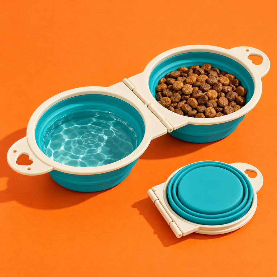 A teal double travel bowl with water and kibble on orange
