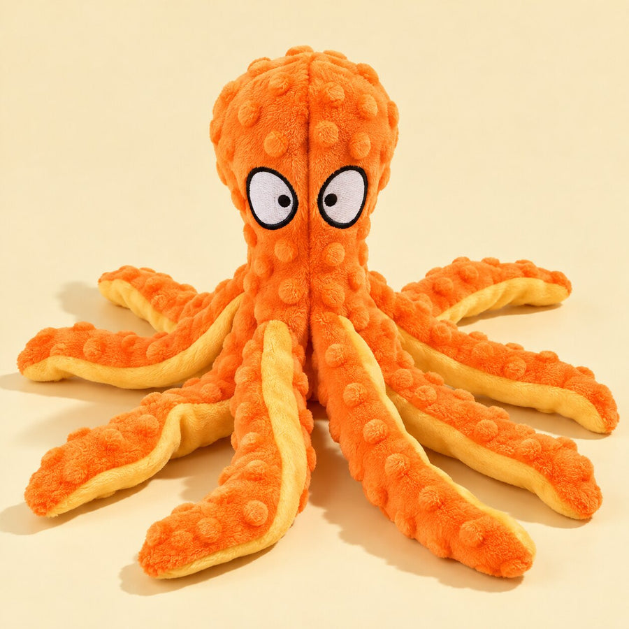 An orange crinkle octopus plush toy on cream