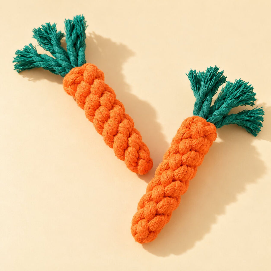 Two braided carrot-shaped rope toys on cream