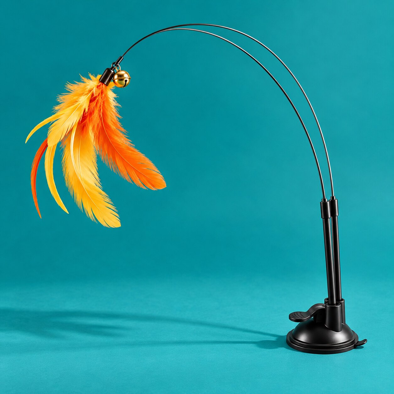 A feather teaser wand for cats on teal